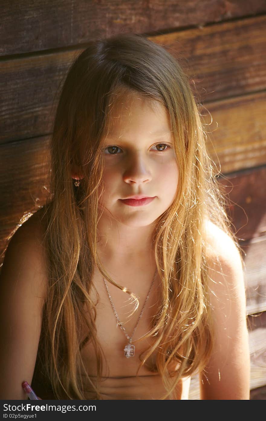 Portrait pensive little Girl in shade at hot day