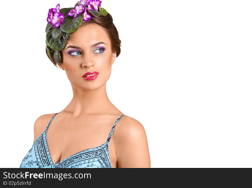 Beautiful girl with a wreath of flowers on her head on the white background