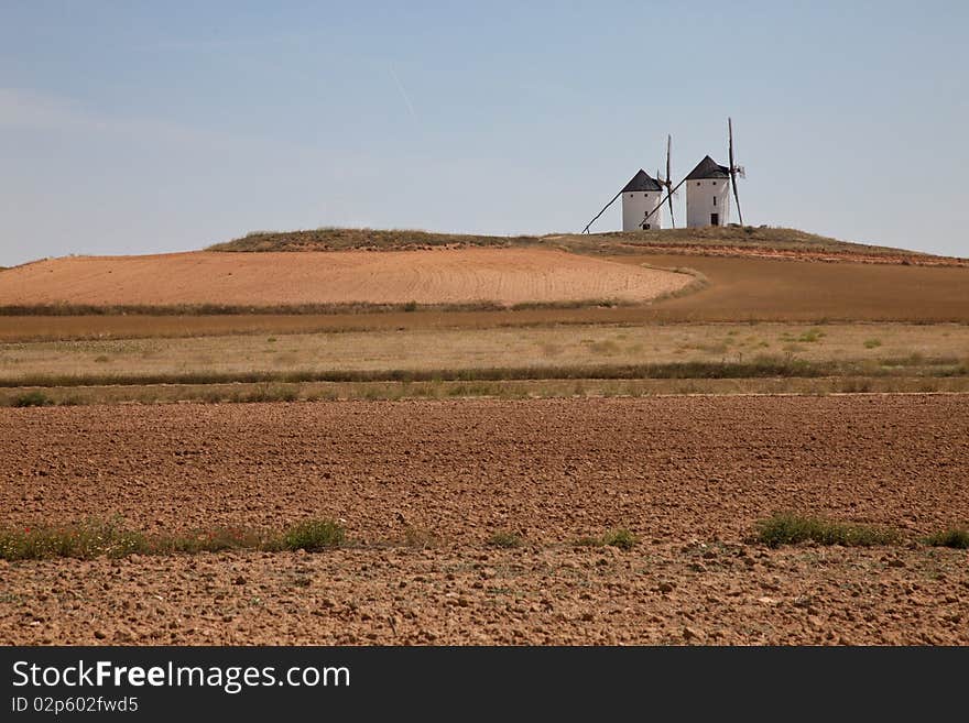 Windmills on top of a hill in Don Quixote's land: Castilla La Mancha, Spain. Windmills on top of a hill in Don Quixote's land: Castilla La Mancha, Spain.