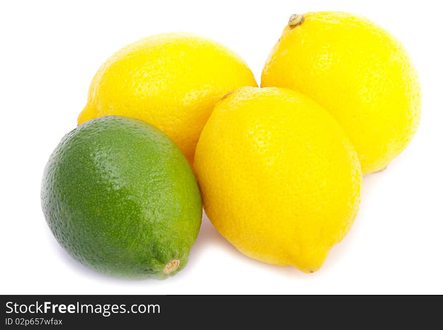 A group of one green limes and three yellow lemons on a white background. A group of one green limes and three yellow lemons on a white background