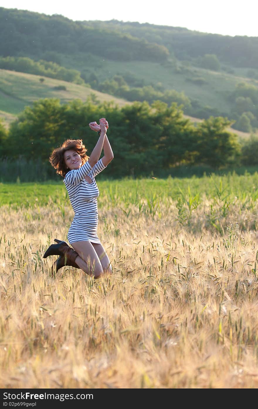 Photo of a young beautiful woman in a wheat field. Photo of a young beautiful woman in a wheat field