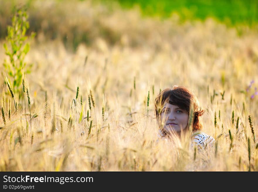 Photo of a young beautiful woman in a wheat field. Photo of a young beautiful woman in a wheat field