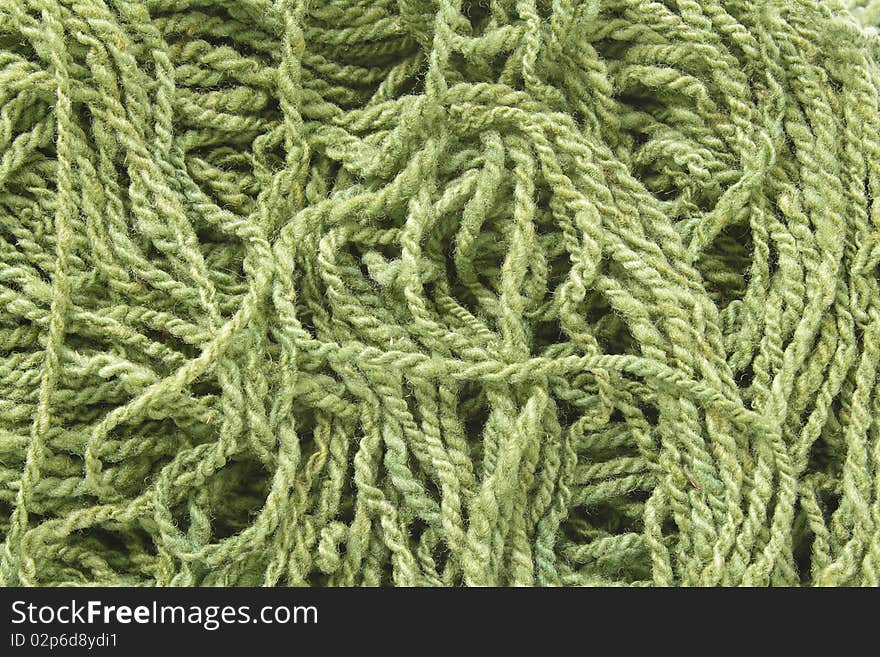 Background with green woolen yarn