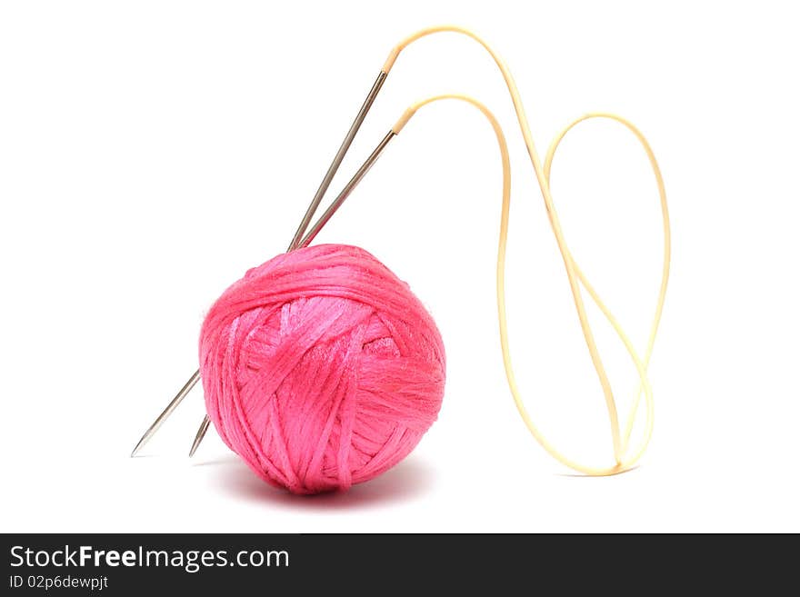 Pink clew with knitting needles isolated on white background. Pink clew with knitting needles isolated on white background