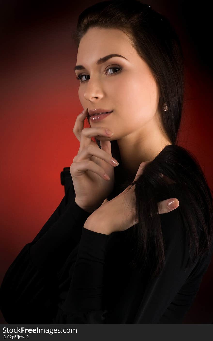 Portrait of beautiful young woman on the red background