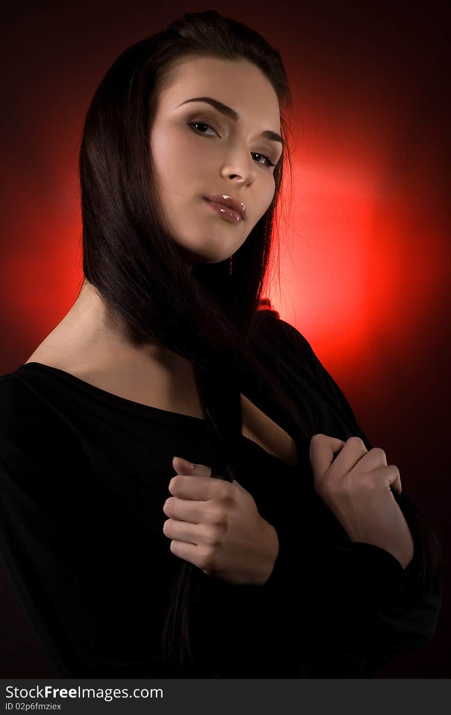 Portrait of beautiful young woman on the red background