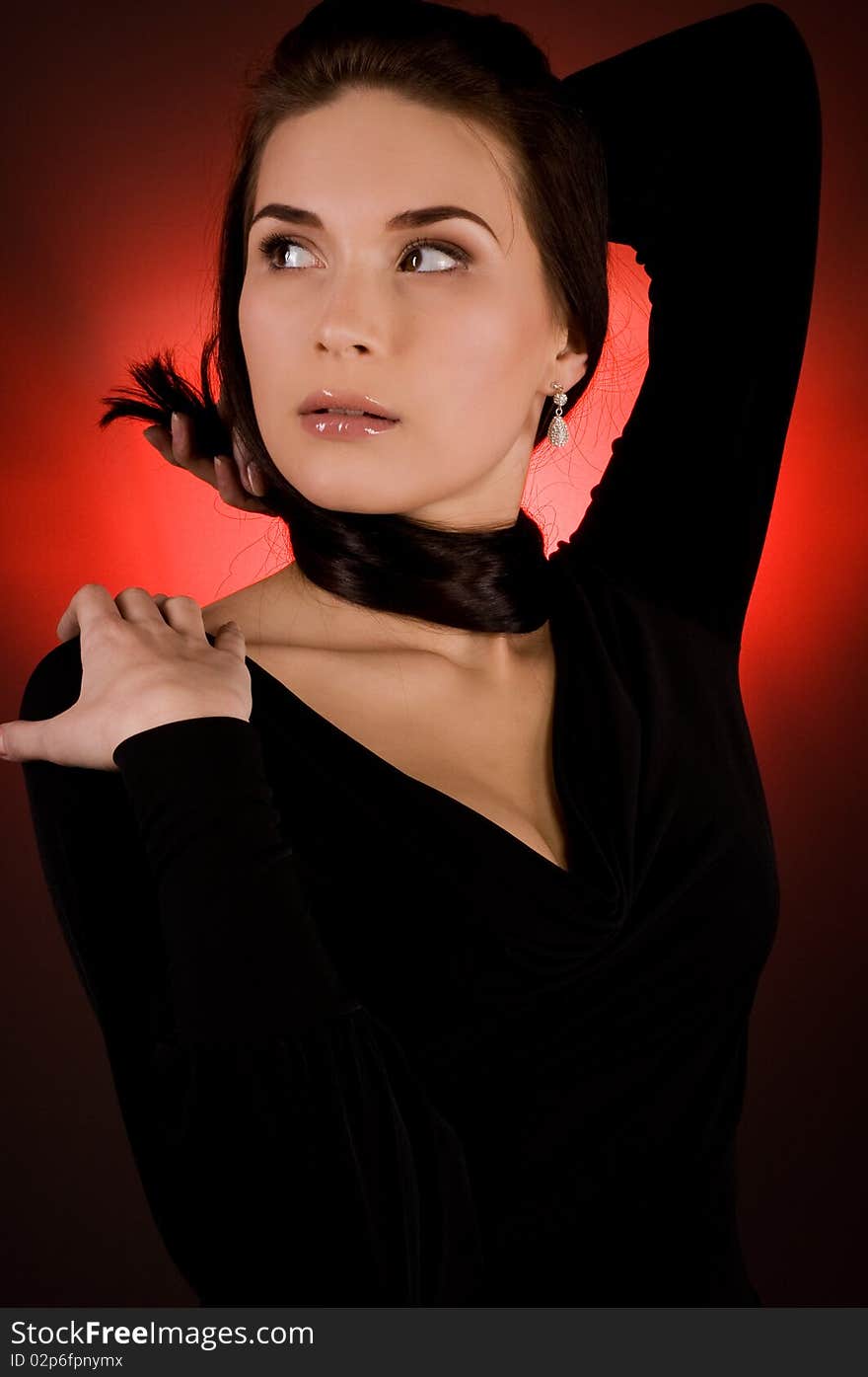 Portrait of beautiful young woman on the red background