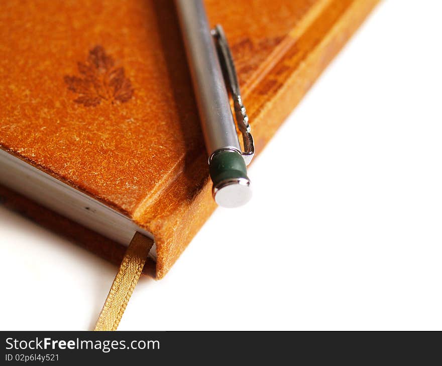 Diary notebook and pen on white background