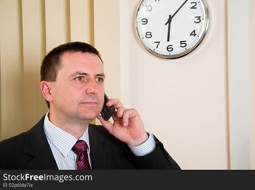 Successful businessman talking on a cell phone. Successful businessman talking on a cell phone