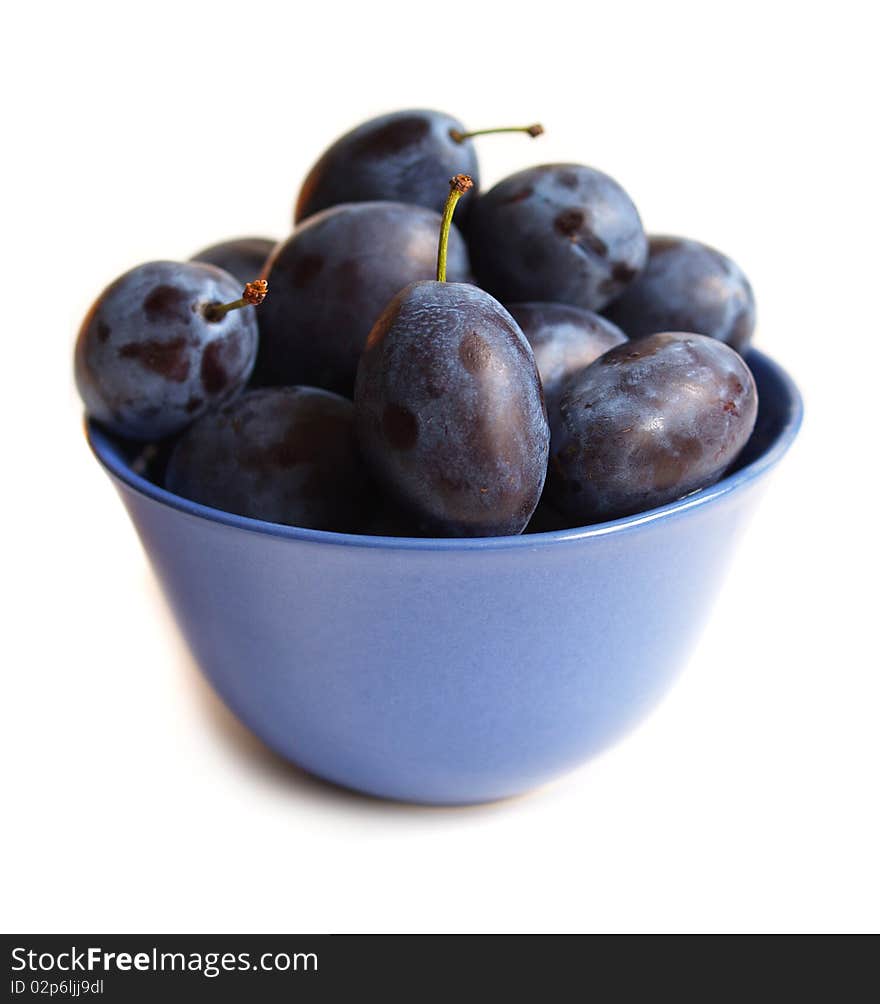 Plums on blue plate