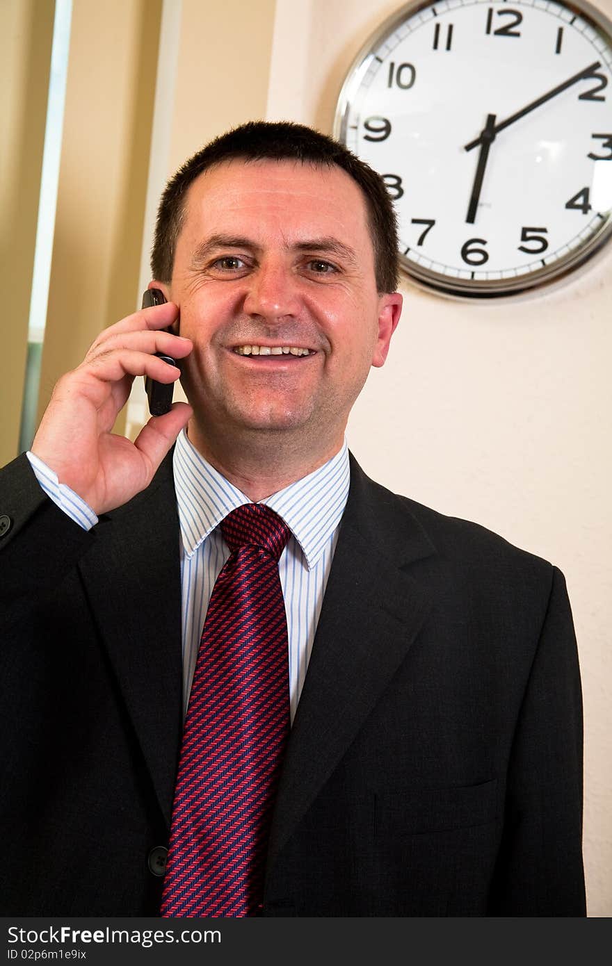 Successful businessman talking on a cell phone. Successful businessman talking on a cell phone