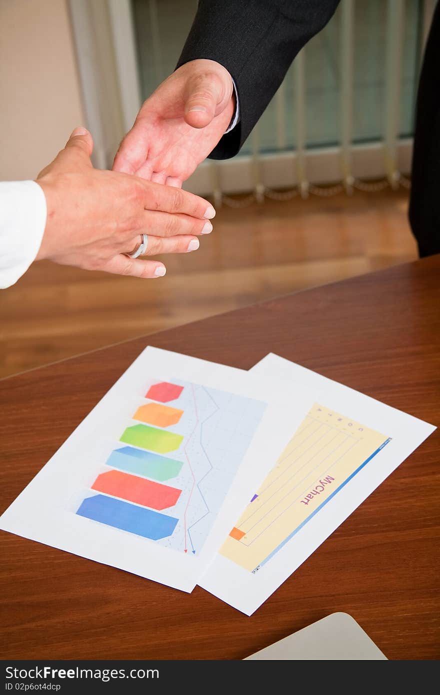 Businessman and woman shaking hands at meeting. Businessman and woman shaking hands at meeting