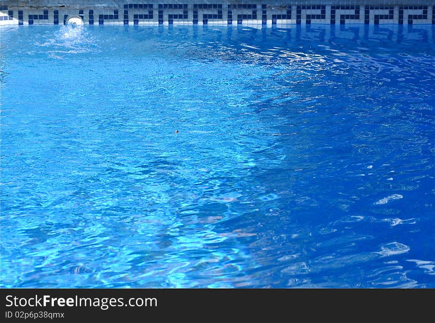 Background of water. It is a swimming pool with a beautiful border design.