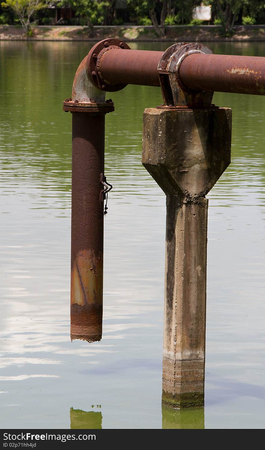 old pipe water in pond. old pipe water in pond