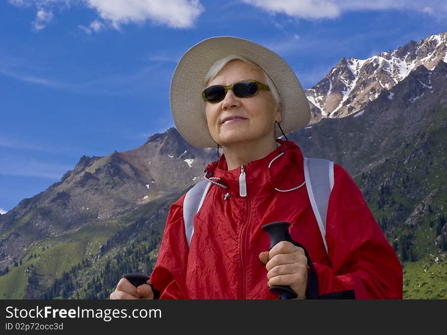 Old women with mountains flowers. Old women with mountains flowers