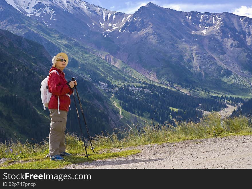 Old women with mountains flowers. Old women with mountains flowers