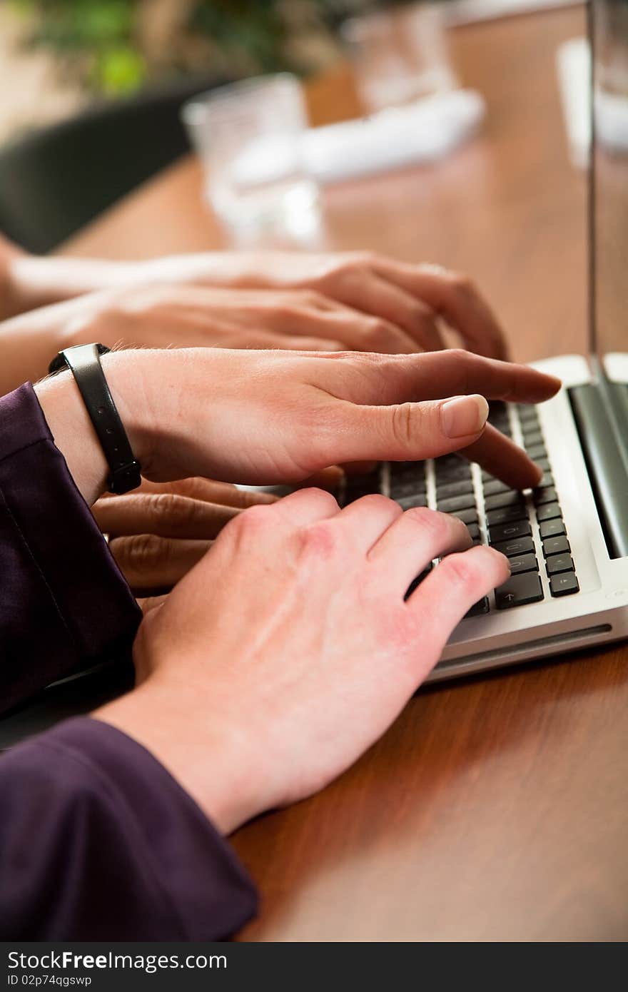 Hands of three business women workingon laptop in the office. Hands of three business women workingon laptop in the office