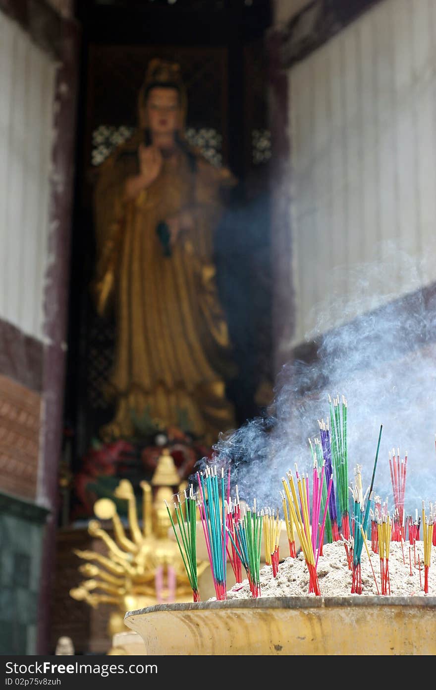 Burning incense for Guan Yin, Krabi Thailand