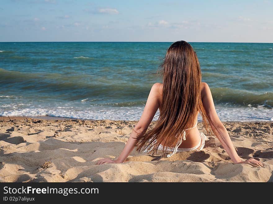 Young beauty woman on sea under sky