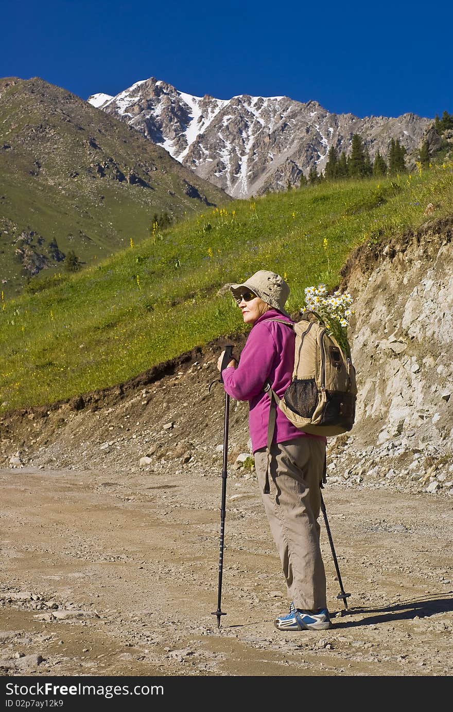 Old women with mountains flowers. Old women with mountains flowers