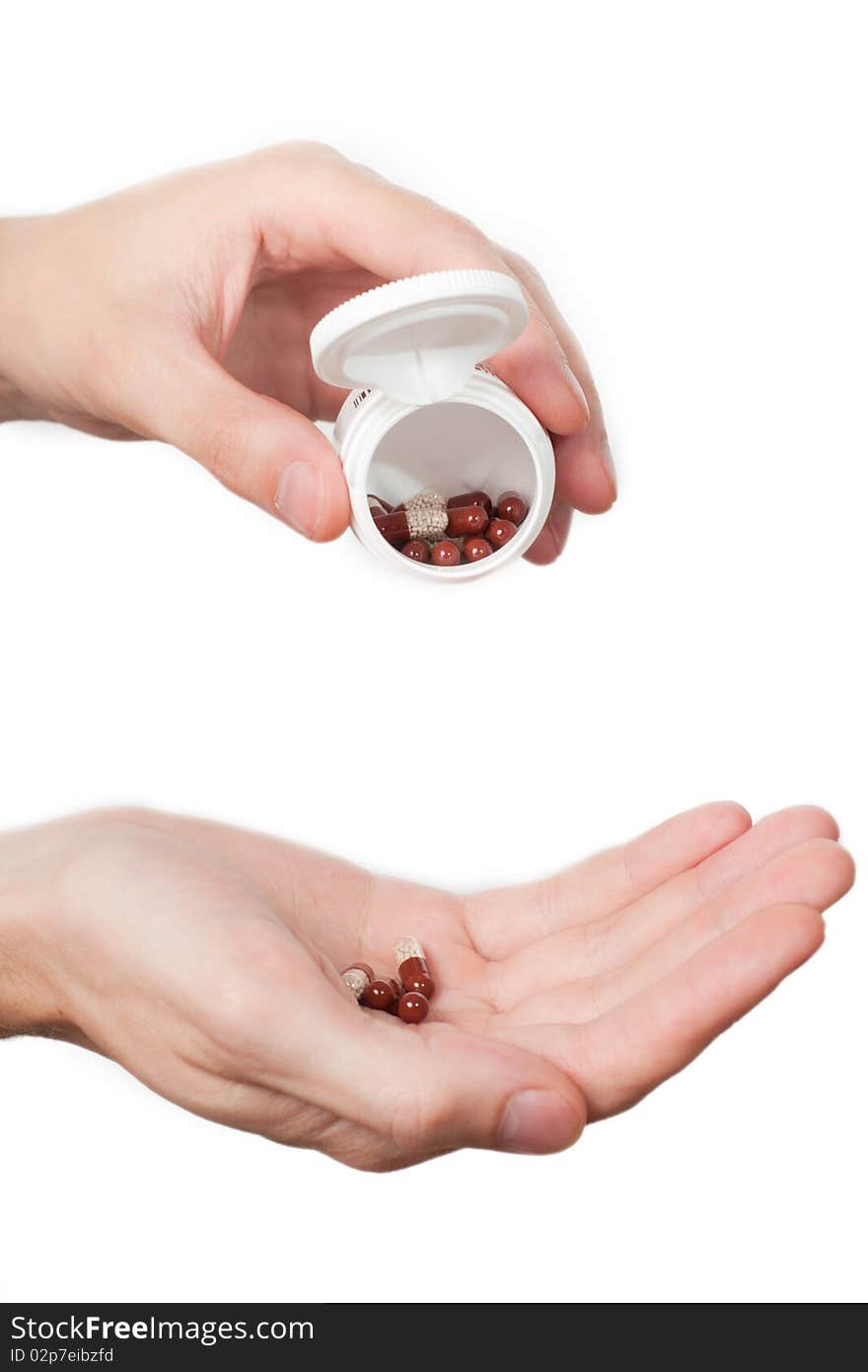 Hand with pills on white background