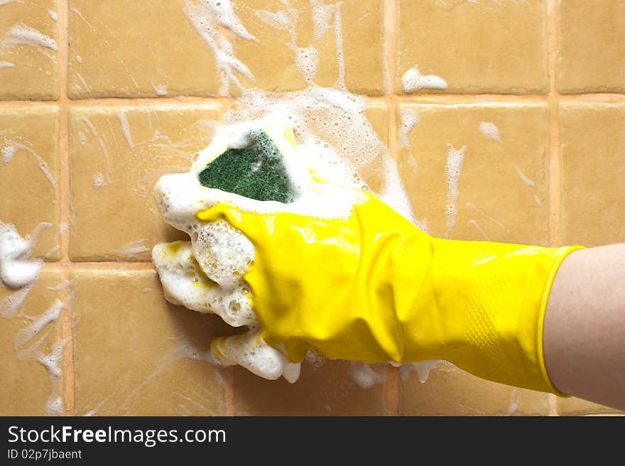 Hand in yellow rubber glove