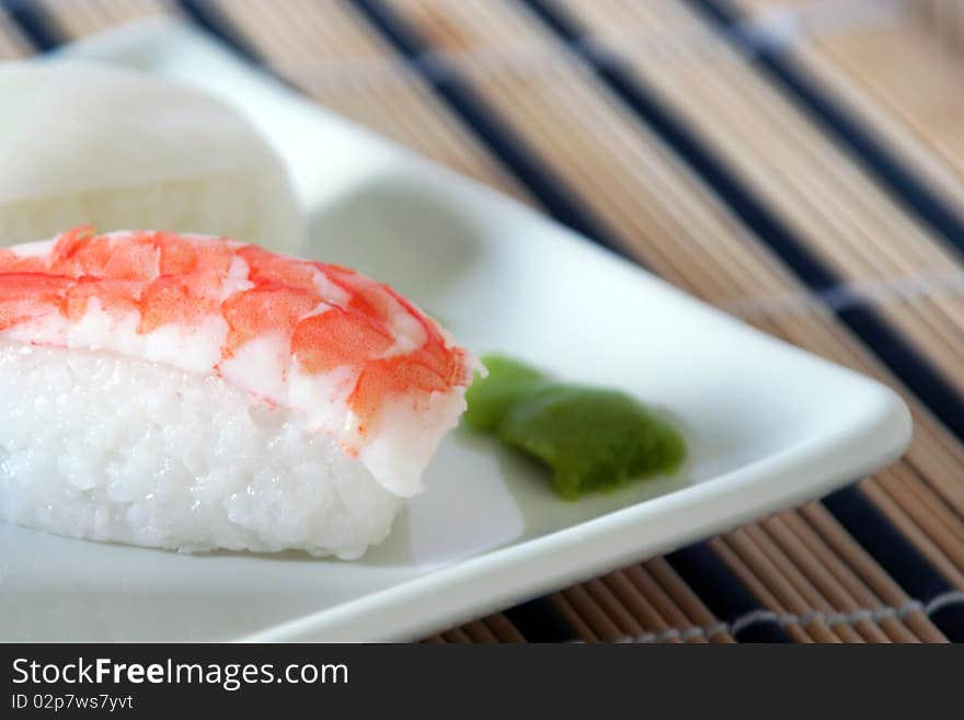 Sushi made of a prawn on a bed of rice and wasabi, detail. Sushi made of a prawn on a bed of rice and wasabi, detail