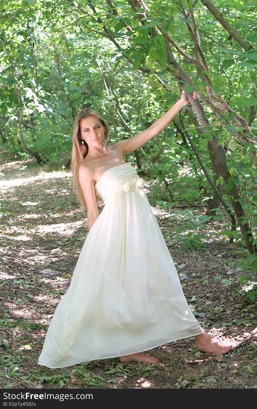 Blond girl in the summer forest