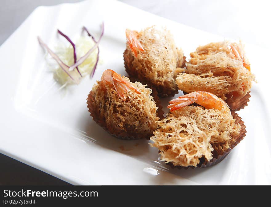 Fried shrimp with decoration in the dish.