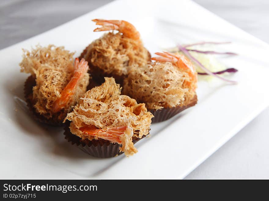 Fried shrimp with decoration in the dish.