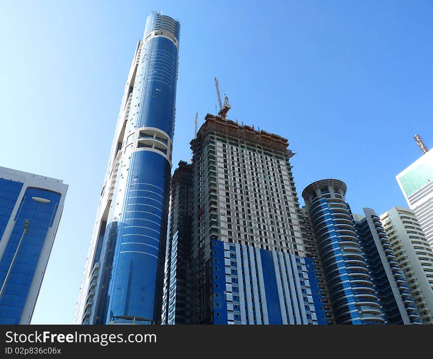 Blue mirrored high rise buildings under construction. Blue mirrored high rise buildings under construction