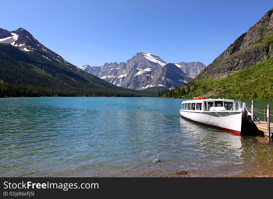 Passenger boat in scenic lake Josephine in Glacier national park