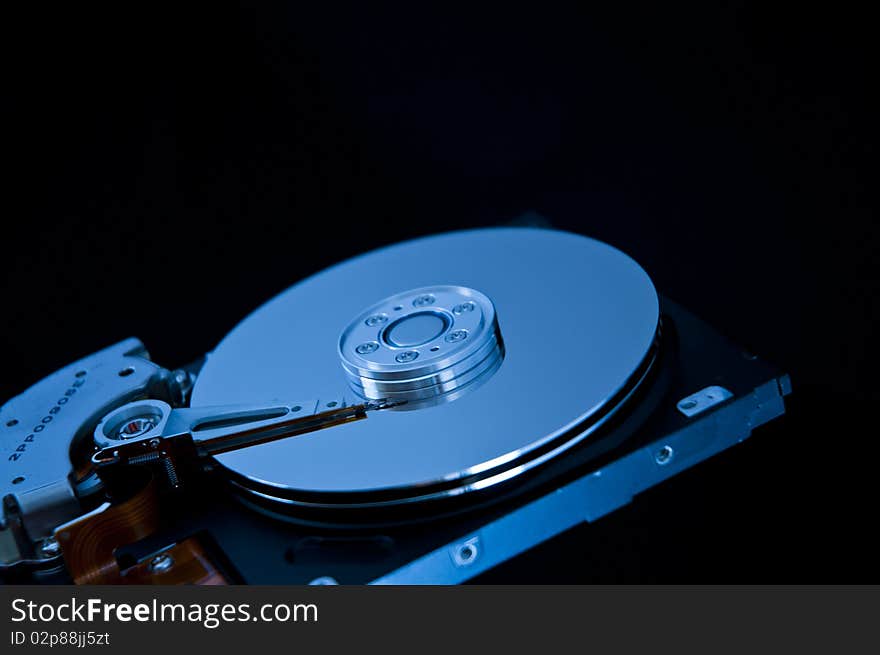 Open hard disk on a black background