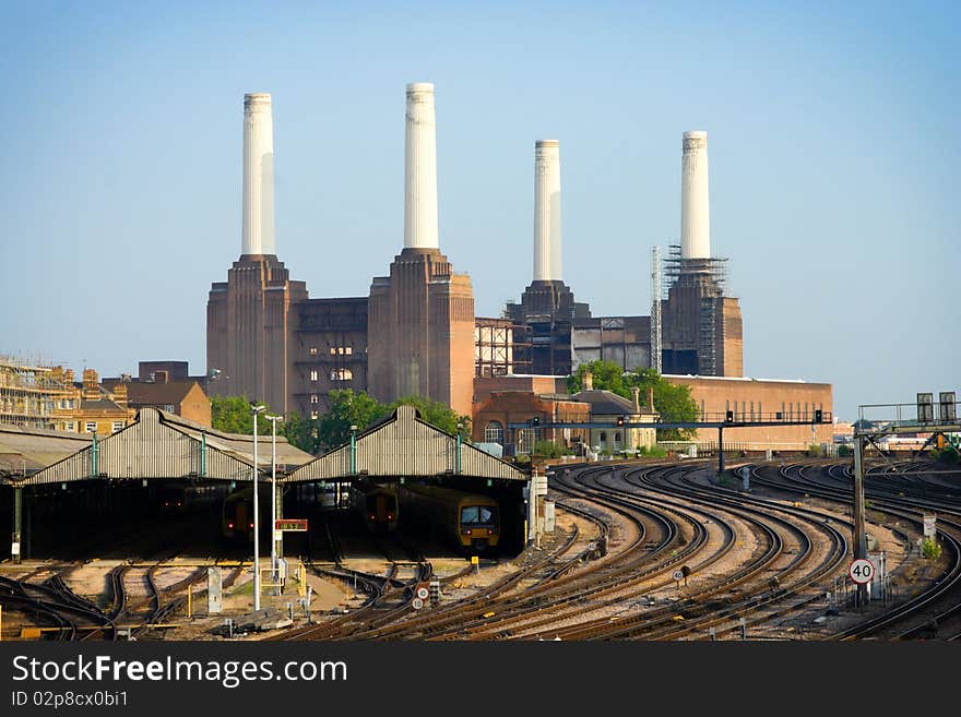 Trains in angars with rails and power station on background, London. Trains in angars with rails and power station on background, London