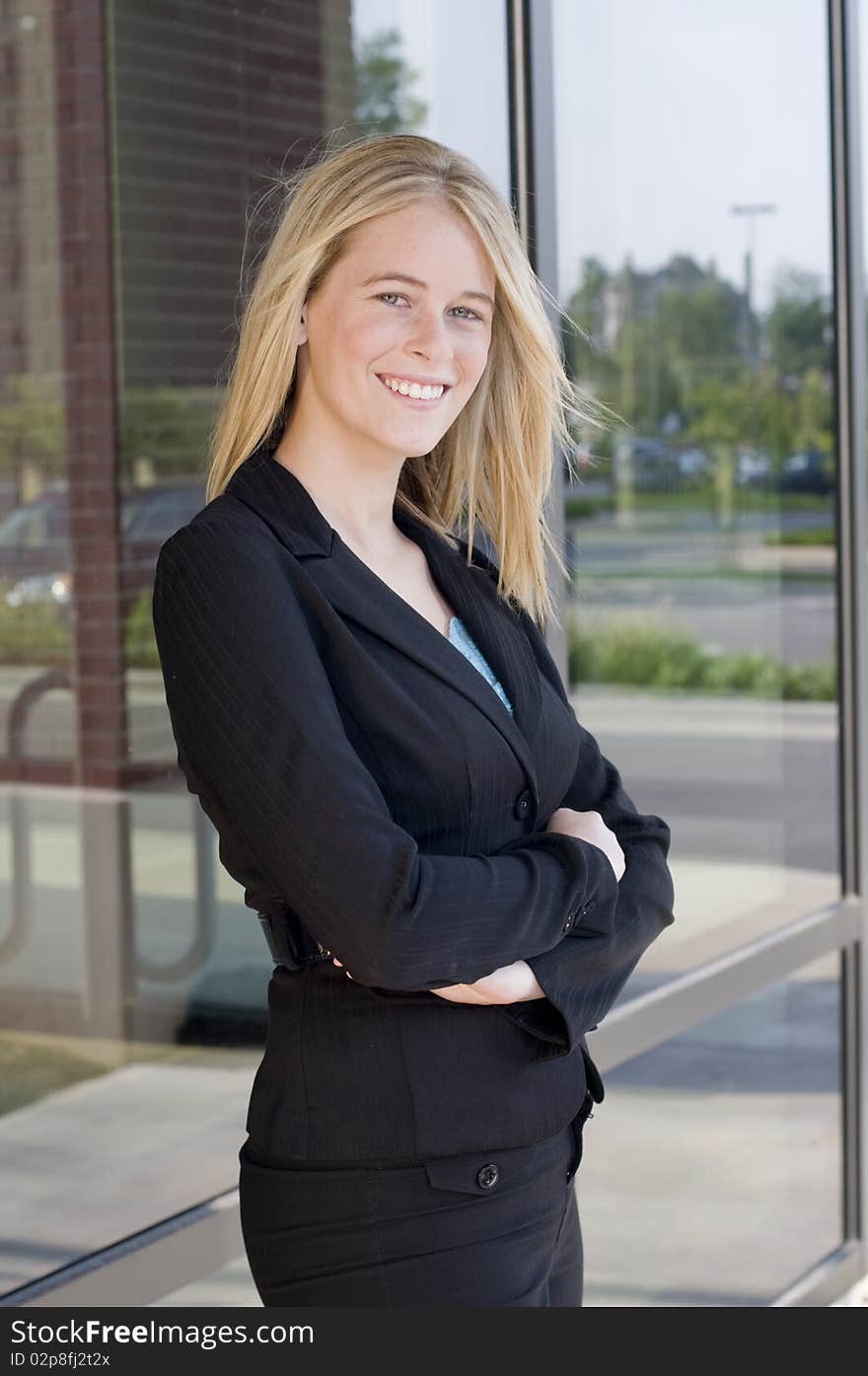 Attractive businesswoman with arms crossed and smiling