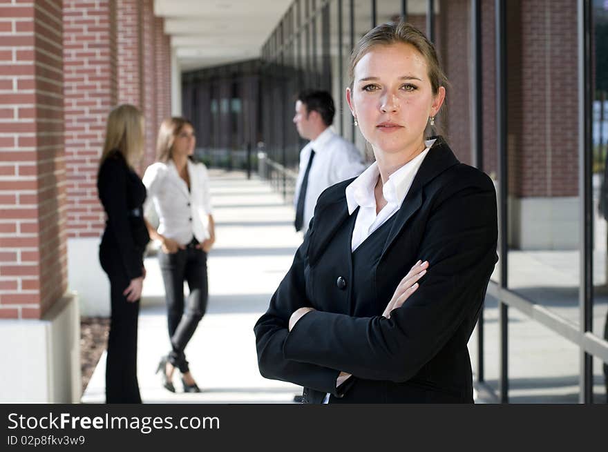 Attractive businesswoman with arms crossed looking at camera