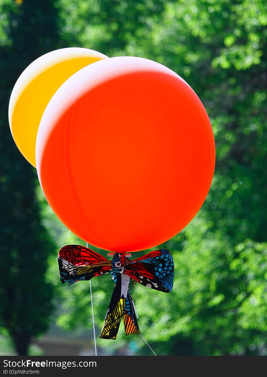 Red and yellow balloons on green background