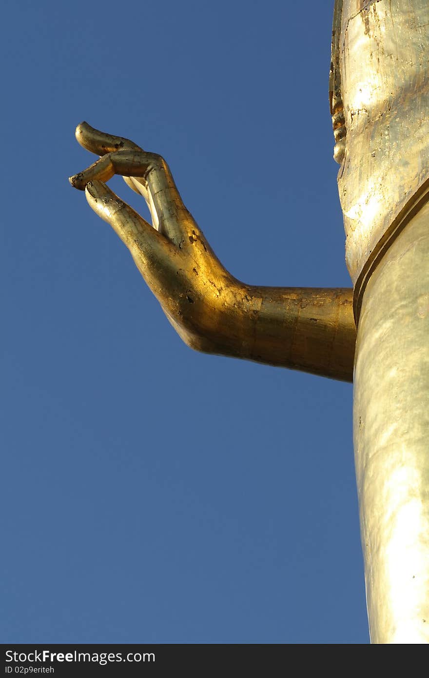 Golden Hand of Buddha whit blue sky