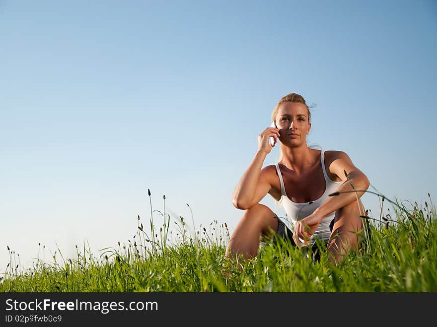 Young woman communicates by phone outdoors. Young woman communicates by phone outdoors