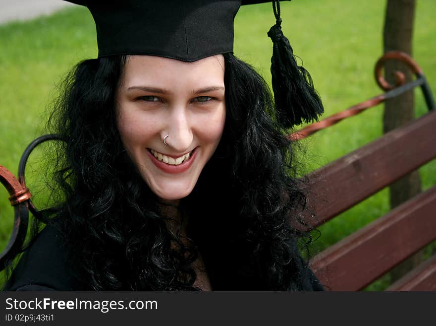 Smiling caucasian student sitting on the bench