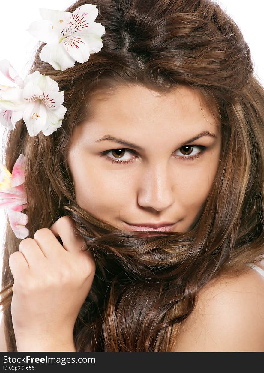 Studio portrait of beautiful young girl with flowers in hair. Studio portrait of beautiful young girl with flowers in hair