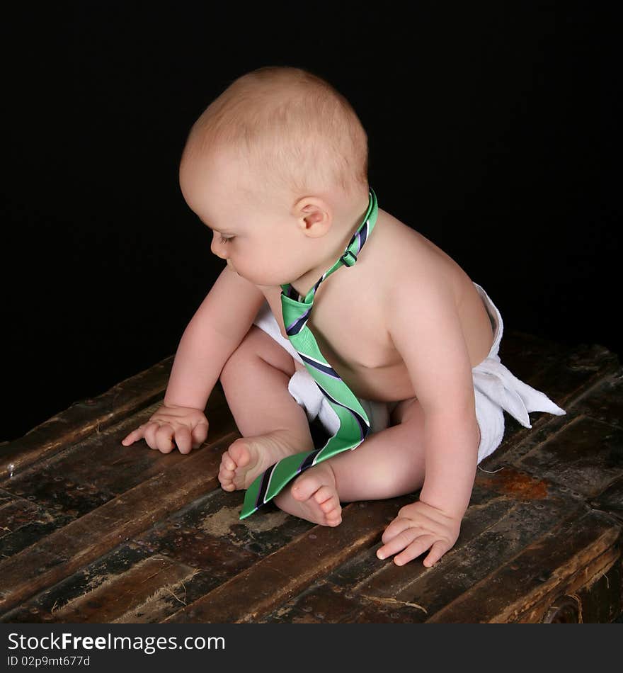 Cute caucasian baby wearing just a tie and diaper. Cute caucasian baby wearing just a tie and diaper