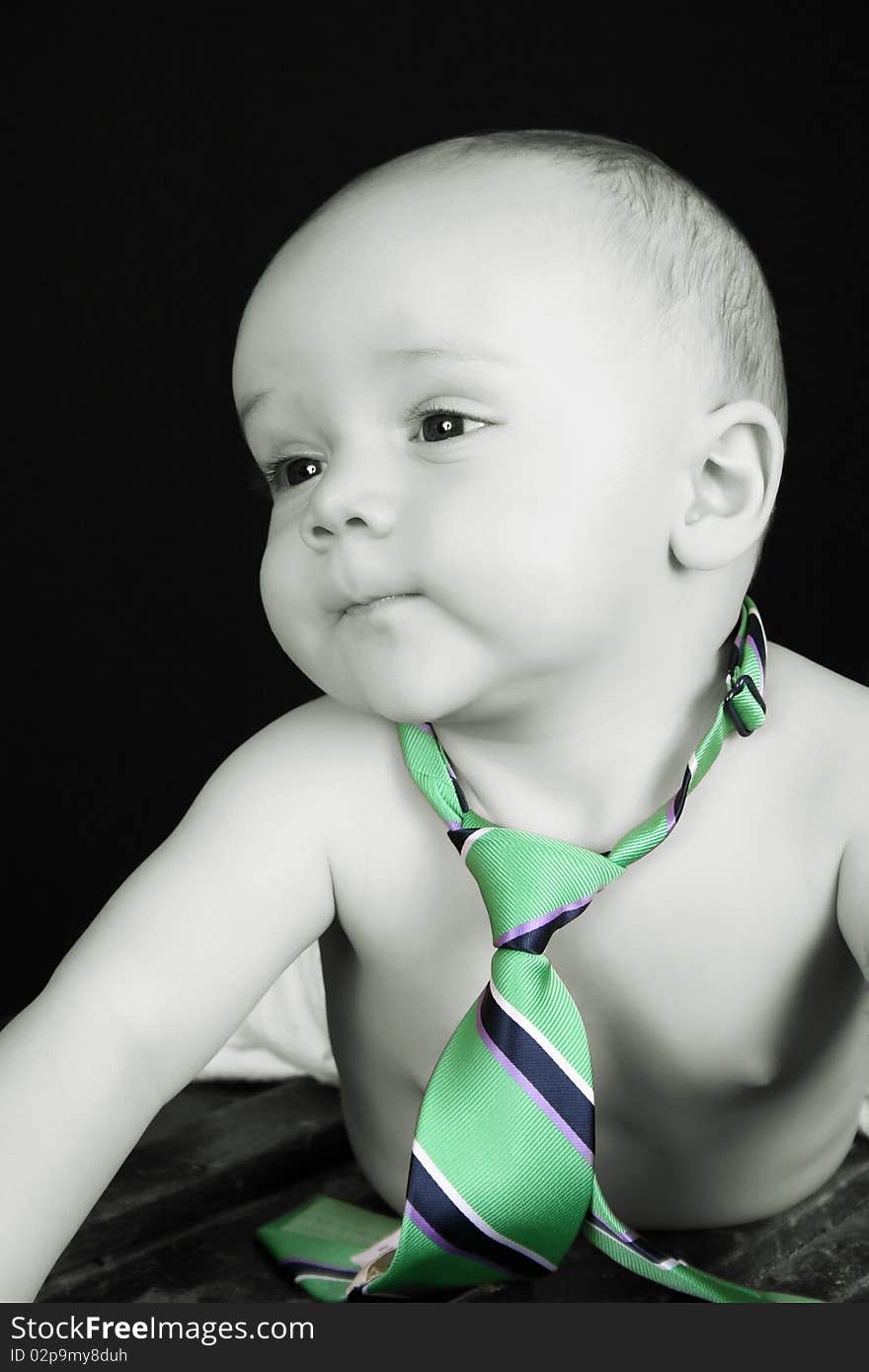 Cute caucasian baby wearing just a tie and diaper. Cute caucasian baby wearing just a tie and diaper