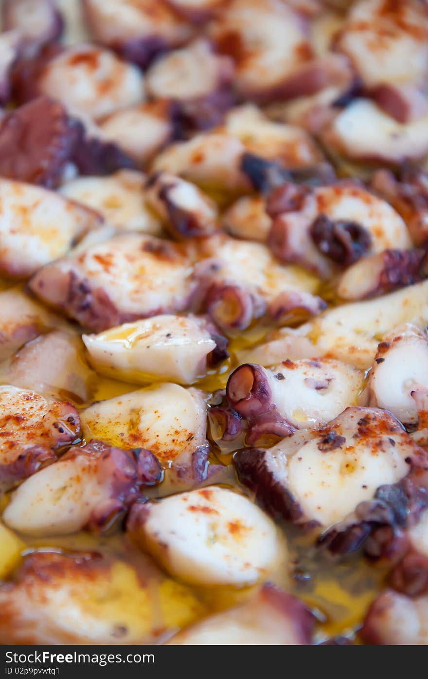 Dish of Galician octopus, with salt, cayenne pepper and olive oil