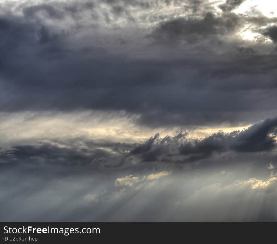 Sunbeams pierce the evening clouds. Sunbeams pierce the evening clouds