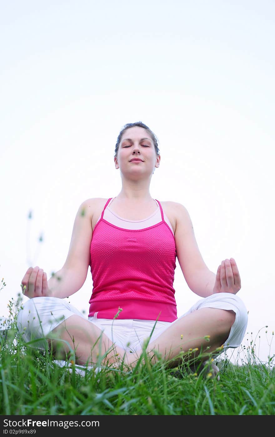 Girl meditating in nature on the grass. Girl meditating in nature on the grass