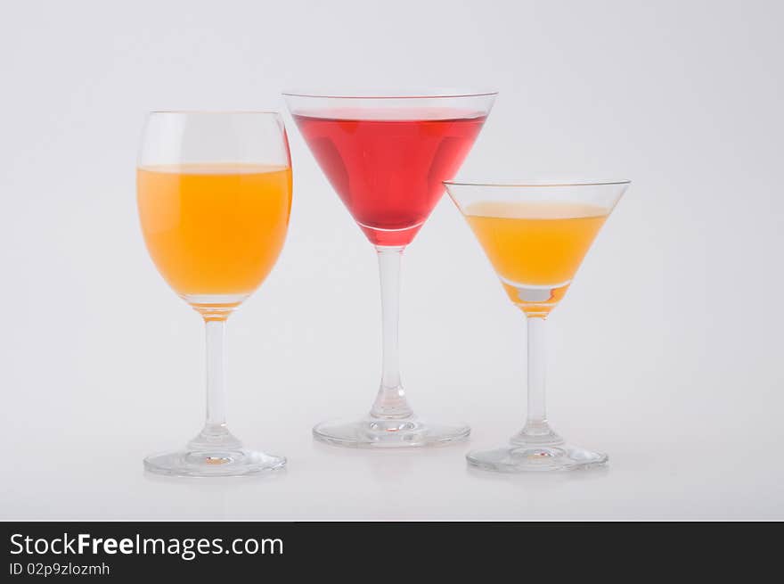 Three glass of fruit juice orange and red on white background