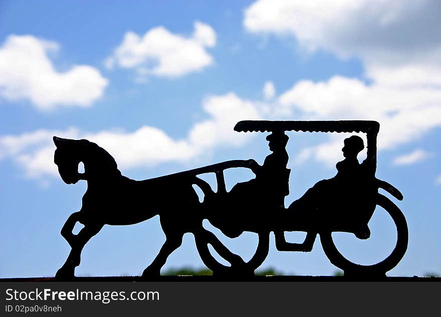 Mailbox decoration, the silhouette of two women in a buggy being pulled by one horse. Mailbox decoration, the silhouette of two women in a buggy being pulled by one horse