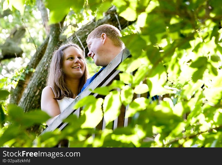 A couple in love series shot in the woods. This image shows the couple in a leaf framed border. The leaves in the foreground are slightly out of focus. Please check out the other image with the couple slightly defocused for a little different spin on the situation. A couple in love series shot in the woods. This image shows the couple in a leaf framed border. The leaves in the foreground are slightly out of focus. Please check out the other image with the couple slightly defocused for a little different spin on the situation.