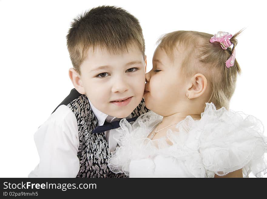 The little girl kisses the brother on a white background. The little girl kisses the brother on a white background.